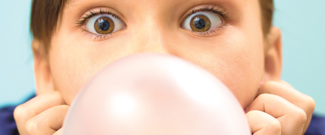 Image of a person blowing a bubble from gum