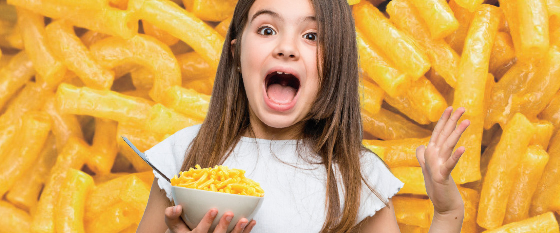 Image of kid holding bowl of mac & cheese against backdrop of mac & cheese